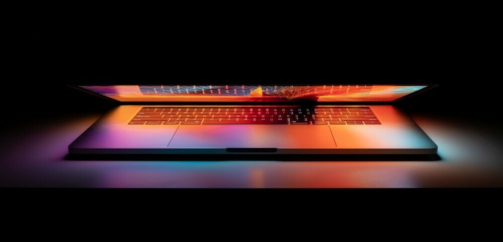 Half open laptop with coloured lights