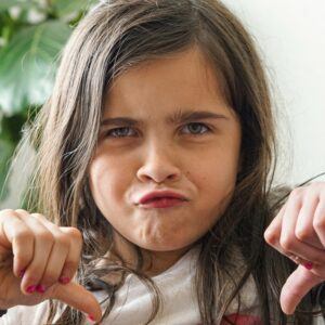 girl showing thumbs down