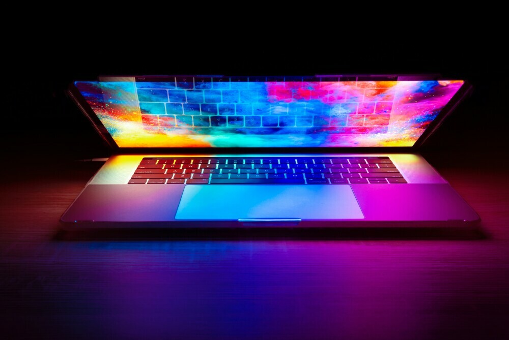 Coloured laptop screen in dark
